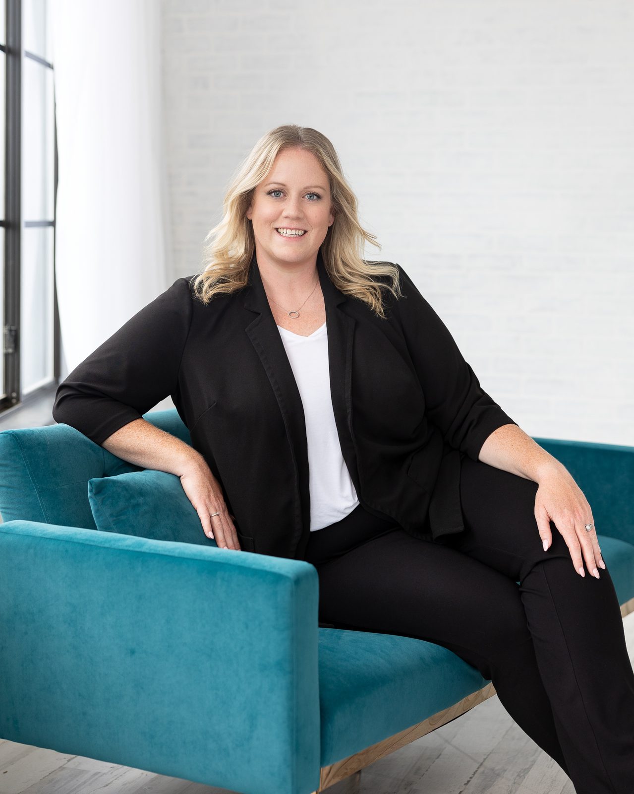 Jen Sanders, founder of Social Magic with Jen, seated and smiling